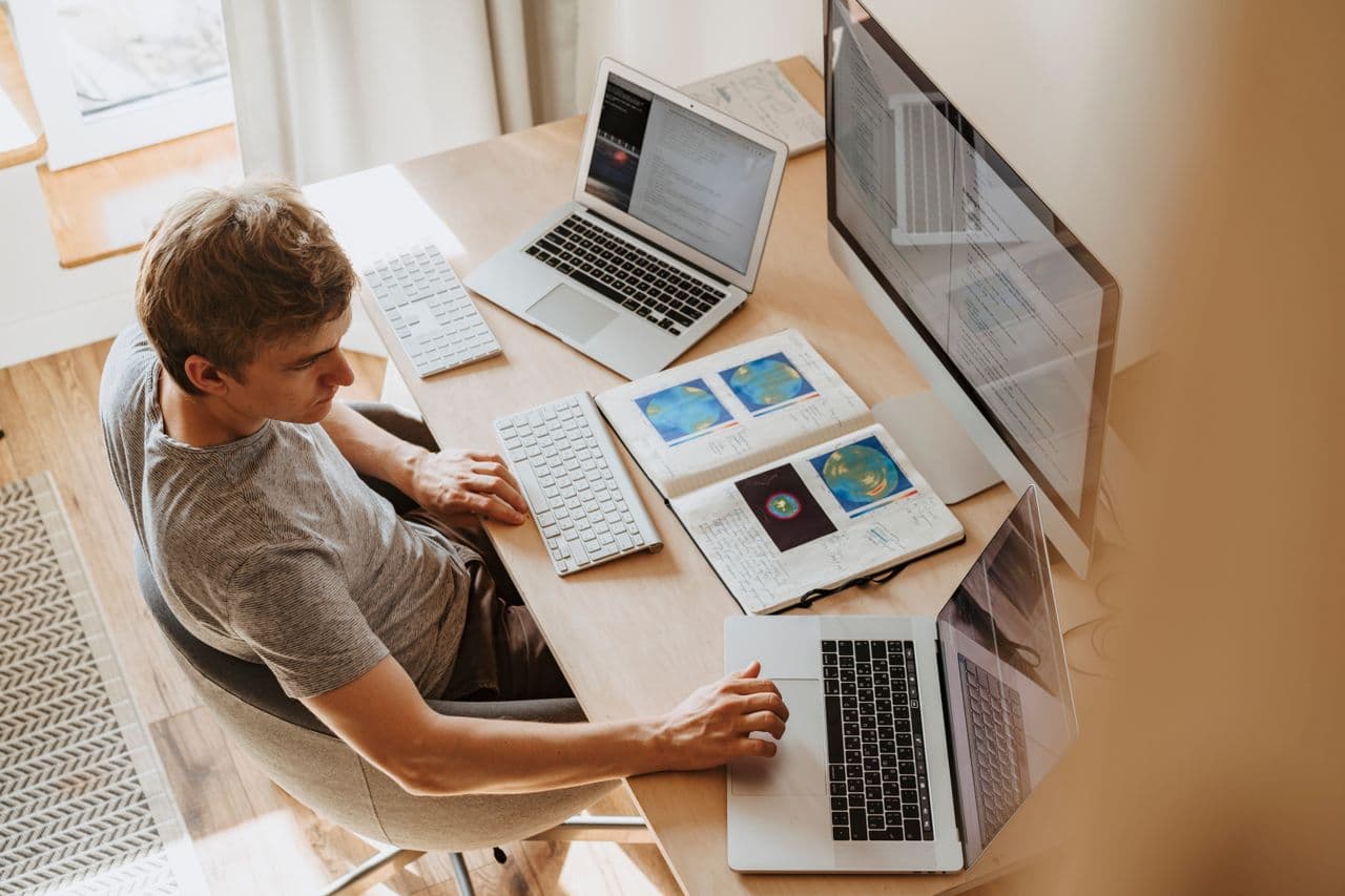 A person working remotely on a laptop at home
