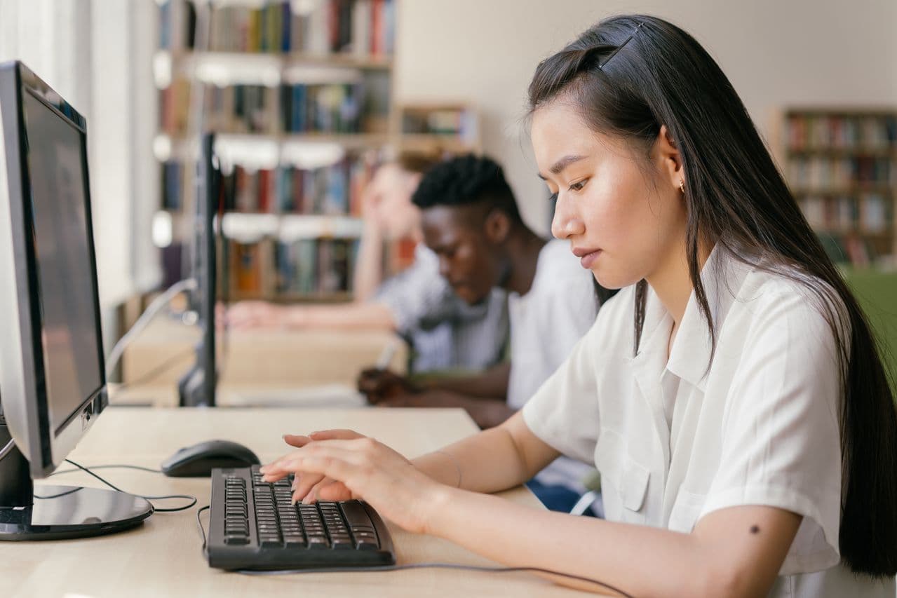 A student using a laptop to study with artificial intelligence