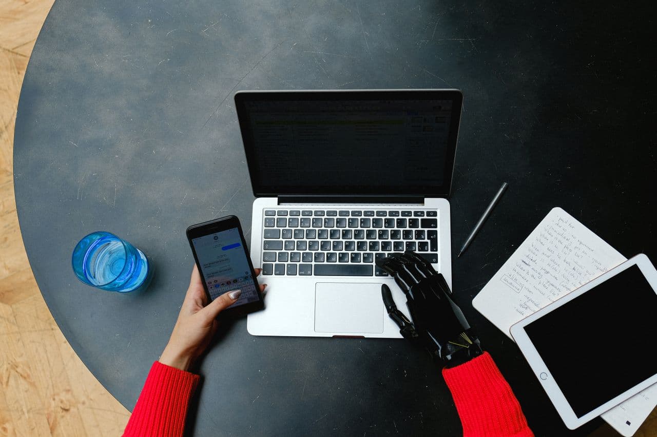 A professional using AI tools on a laptop in a modern workplace