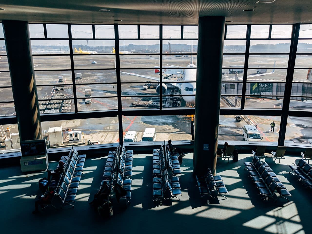 Passengers waiting at an airport gate before a flight